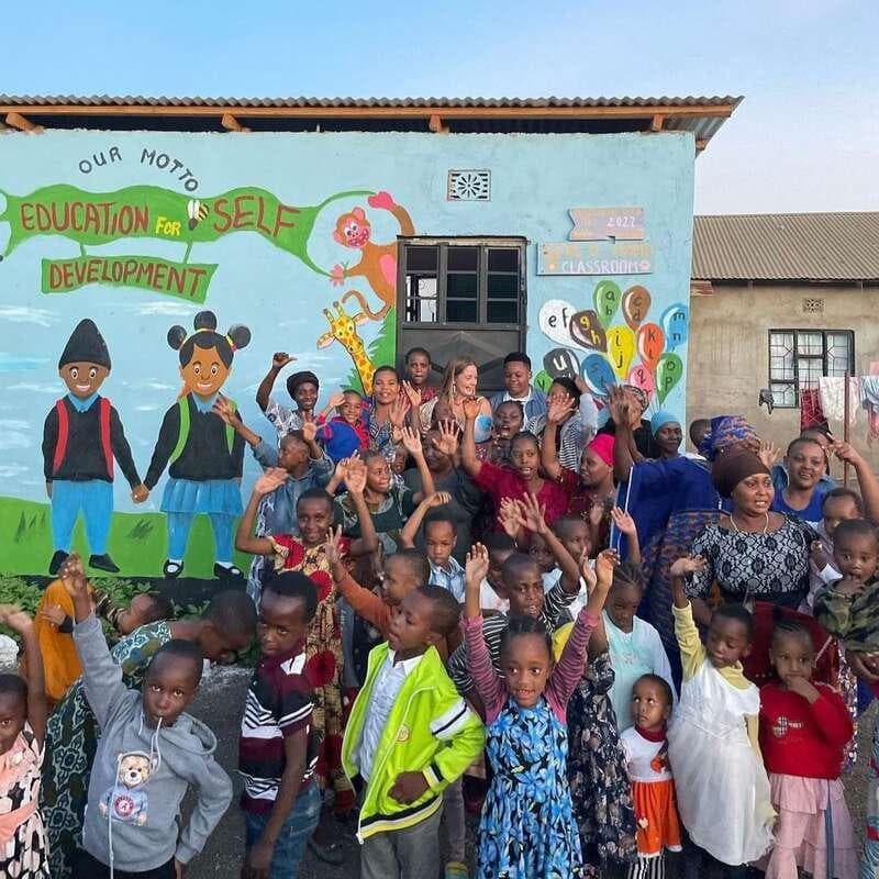 Children and community members gathered outside a school